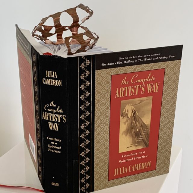 1st Generation - Fold Formed Copper displayed with folded book The Artist Way by Julia Cameron