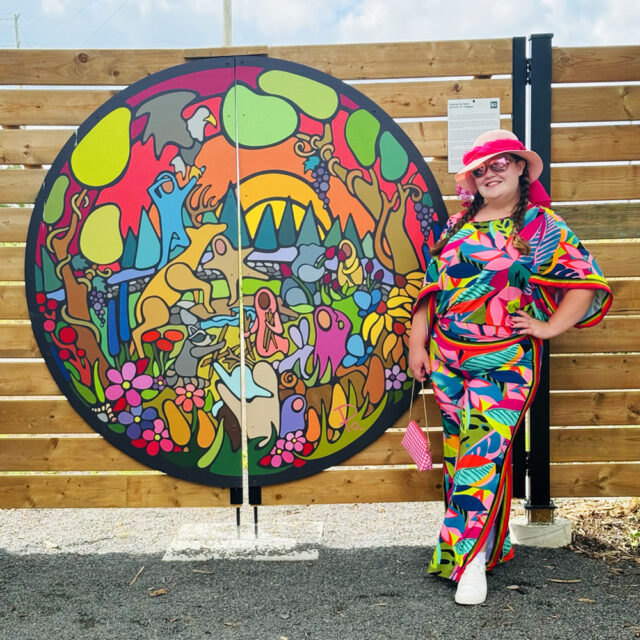 Po with her hand brush painted mural 