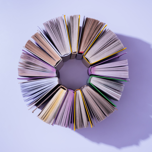 A circle made of books, spines facing in and pages fanning out.