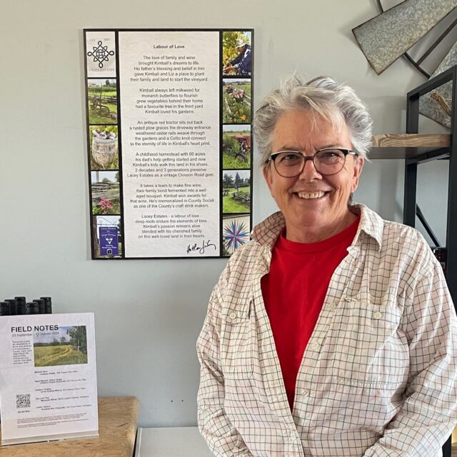 Heather Lindsay with her poetry displayed during Alchemy Artist Residency's  Field Notes, 2024